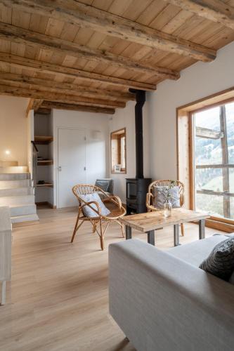 a living room with a couch and a table at La ferme d'Hauteluce - Chalets in Hauteluce
