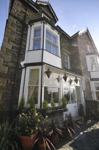a house with plants in front of it at St John's Lodge incl off-site leisure club in Windermere