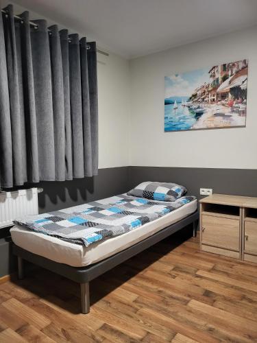 a bed in a room with black curtains at Pokoje u Piotra in Tczew