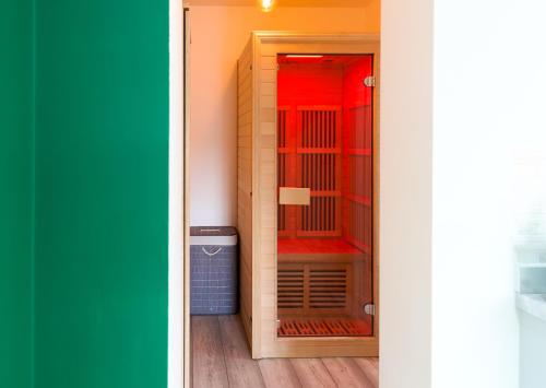 a room with a closet with red and green at PopArt Studio CITY CENTRE SAUNA BALCONY, PRIVATE PARKING, WIFI NETFLIX- HAVEN4u in Hatfield