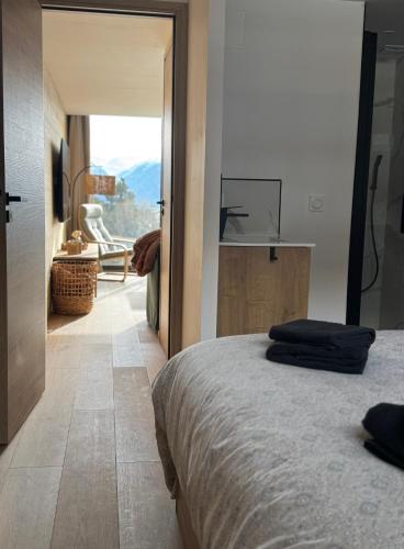 a bedroom with a bed with a tv on the wall at Le 1790 "Premium Service" in Égat