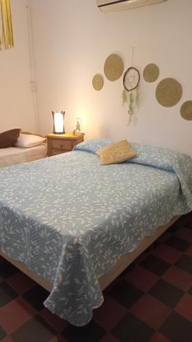 a bedroom with a bed and a clock on the wall at La Guadalupana in Mina Clavero