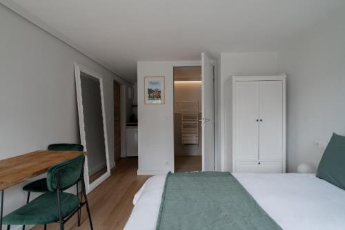 a bedroom with a bed and a desk and a table at La ferme d'Hauteluce - Chambre d'hôtes in Hauteluce