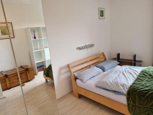 a bedroom with a bed and a glass wall at Tischfussball Quartier Köln-Niehl in Cologne