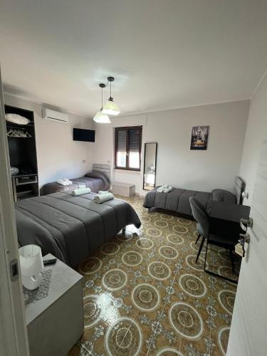 a large bedroom with two beds and a couch at La Stazione bed and breakfast in Boiano