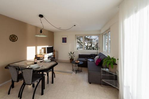 a living room with a couch and a table at Ferien im Paradies - Wohnung Vera in Höchst