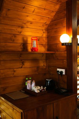 a room with a wooden wall with a red lamp at EllaCrest by Aloft in Kumbalwela