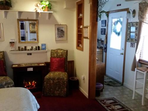 a room with a fireplace and a bed and a chair at 1 Murray House in Newport