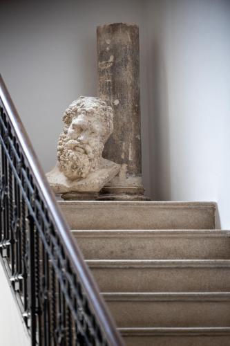 a statue sitting on top of some stairs at Palazzo Piccinno in Parabita