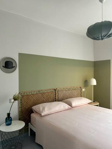 a bedroom with a large bed and a table at Casa I Merletti in Lunano