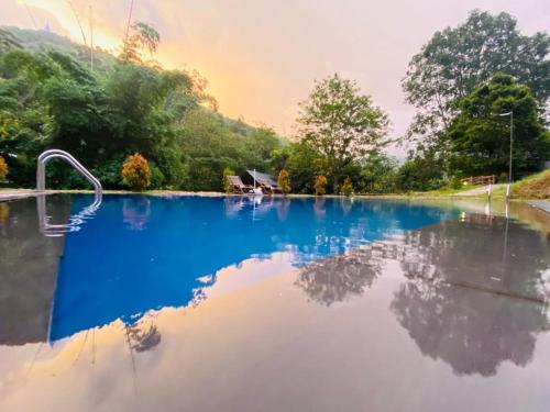 a large pool of water with the sky in the background at EllaCrest by Aloft in Kumbalwela
