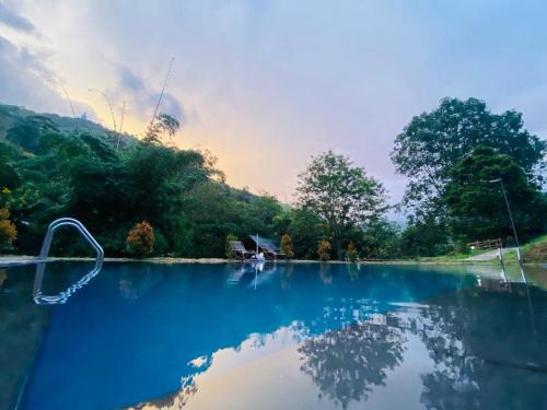 a river with a reflection of a house in the water at EllaCrest by Aloft in Kumbalwela