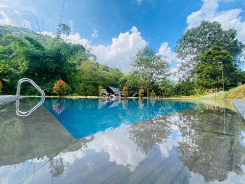 a reflection of the sky in a pond at EllaCrest by Aloft in Kumbalwela