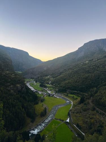 an aerial view of a river in a valley with mountains at Grandma`s house in Flåm