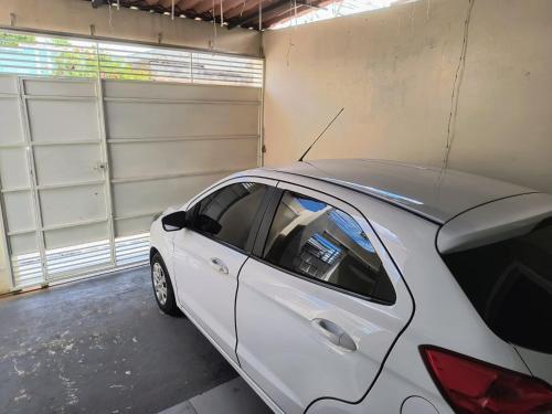 a white car parked in a garage at Casa mobiliada para Cop 30 in Ananindeua