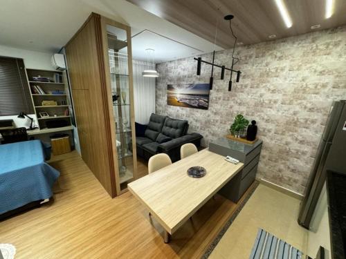 a living room with a table and a couch at Studio completo e bem localizado in Jaú