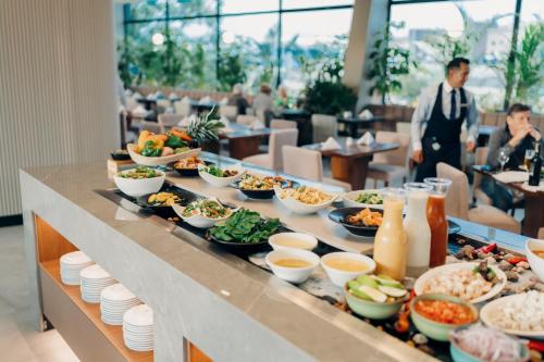 a buffet line with dishes of food on it at Wyndham Quito Airport in Tababela