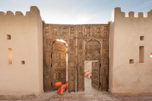 an entrance to a building with a large wooden door at Four Seasons Resort Marrakech in Marrakech
