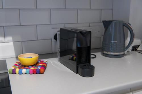 a microwave sitting on a kitchen counter with a cup at 7Kamares in Pano Lefkara