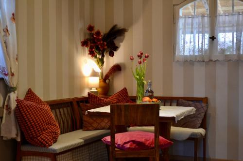 a dining room with a table and a vase of flowers at BaoBa-GRACE BnB in Laufenburg