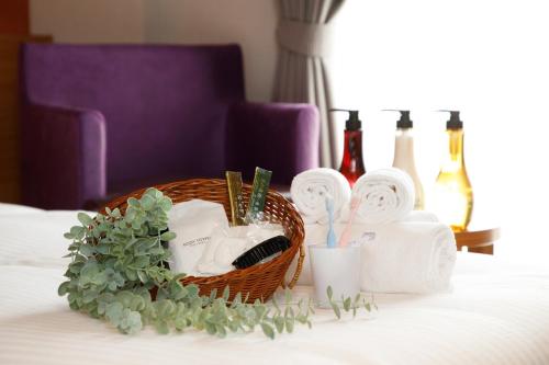 a basket of towels and toiletries on a bed at FIVE HOTEL OSAKA - Vacation STAY 10370v in Osaka