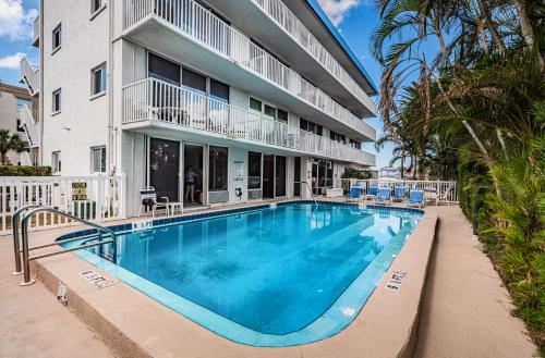 a swimming pool in front of a building at Charming and Spacious Studio in Clearwater Beach