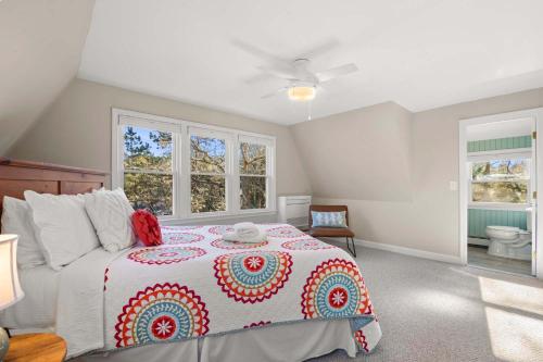 a bedroom with a bed with a red and white blanket at Unique A Frame Short Drive to Beach in Barnstable