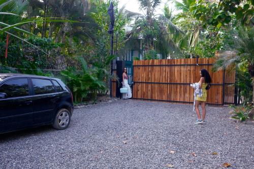 a woman standing in front of a fence at Wabi Sabi Sora in Punta Uva