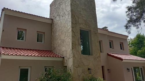 a building with a tower on the side of it at Wonderful Luxury House in Benavídez