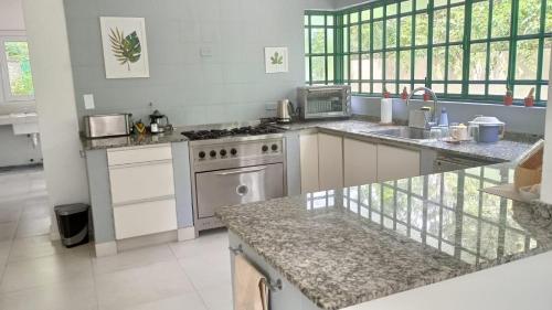 a large kitchen with a stove and a sink at Wonderful Luxury House in Benavídez