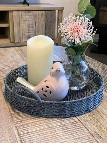 a candle and a candle holder on a table at Ravensbourne Escape- Quingilli in Ravensbourne