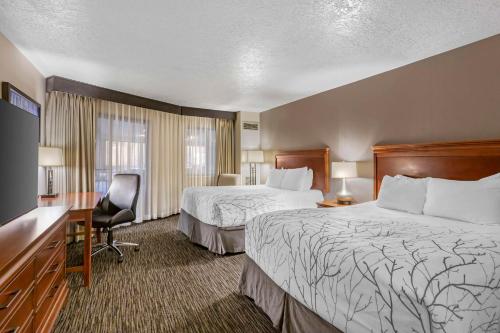a hotel room with two beds and a desk at Best Western Plus Landmark Inn in Park City