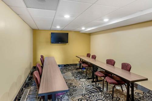 a conference room with tables and chairs and a tv at Best Western Plus Landmark Inn in Park City
