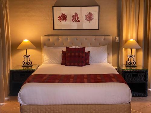 a bedroom with a large bed with two lamps at Berenbell Vineyard Retreat in Pokolbin