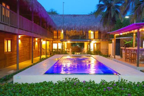a swimming pool in the backyard of a house at night at Awa de Mar Playa in Tolú