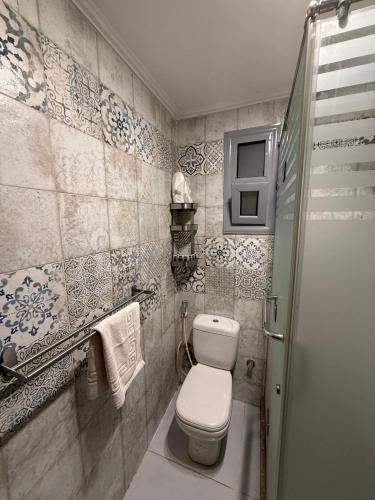 a bathroom with a toilet and a sink at Queen Cleopatra Boutique Hotel in Cairo