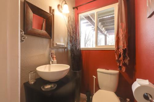 a bathroom with a sink and a toilet and a window at 7 Mi to Clear Lake Home with Peaceful Deck! in Kelseyville
