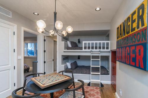 a room with a bunk bed and a table and chairs at Luxury at Miles High, with 2 Free Ski Passes in Telluride