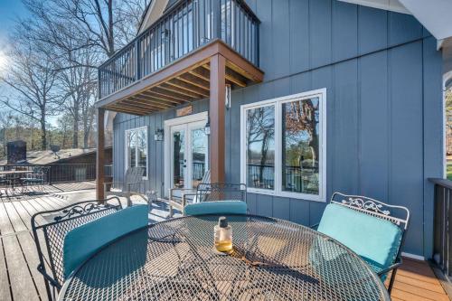a patio with a table and chairs on a deck at Private Boat Dock Troutman Home on the Water! in Terrell