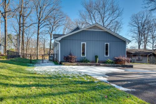 a gray house with a fence and a yard at Private Boat Dock Troutman Home on the Water! in Terrell