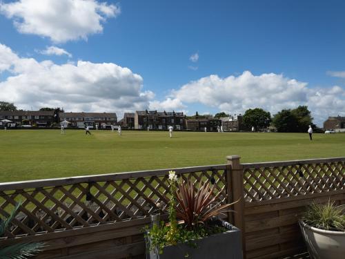 a baseball game being played on a field at Cricketers View in Bradford