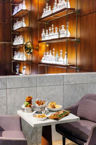 a table with plates of food on top at Sheraton Grand Los Angeles in Los Angeles