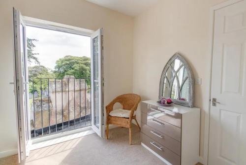 a room with a dresser and a large window at Highland Chapel in Weymouth