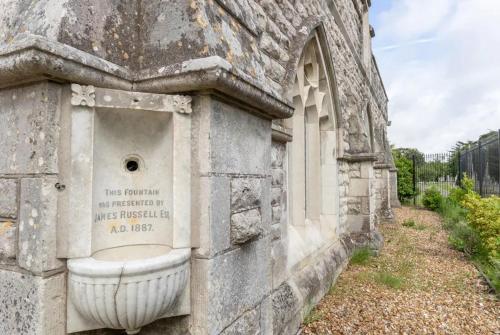 a stone building with a sink on the side of it at Highland Chapel in Weymouth