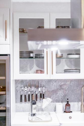 a kitchen with white cabinets and a sink at Boho Chic Home in Town Center in Viersen