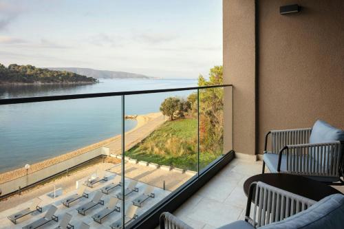 a balcony with chairs and a view of the water at The Isolano, Adults Friendly Resort, Autograph Collection - 12years and above in Cres