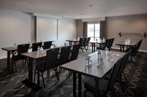 a conference room with tables and chairs with water bottles on them at Residence Inn Syracuse Carrier Circle in East Syracuse