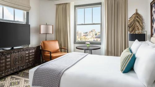 a hotel room with a bed and a television at Hotel Spero, Vignette Collection by IHG in San Francisco