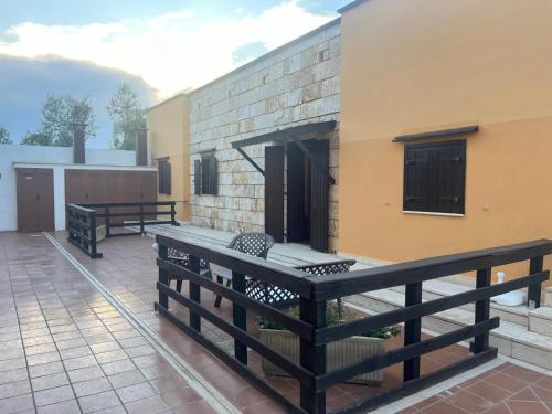 a patio with two benches and a building at Casal Mastro appartamenti e camere con piscina in Bisceglie
