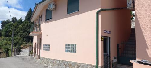 a building with green shutters on the side of it at CasaPinto in Castro Daire